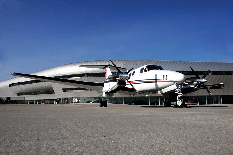 King Air parked in front of Farnborough airport terminal